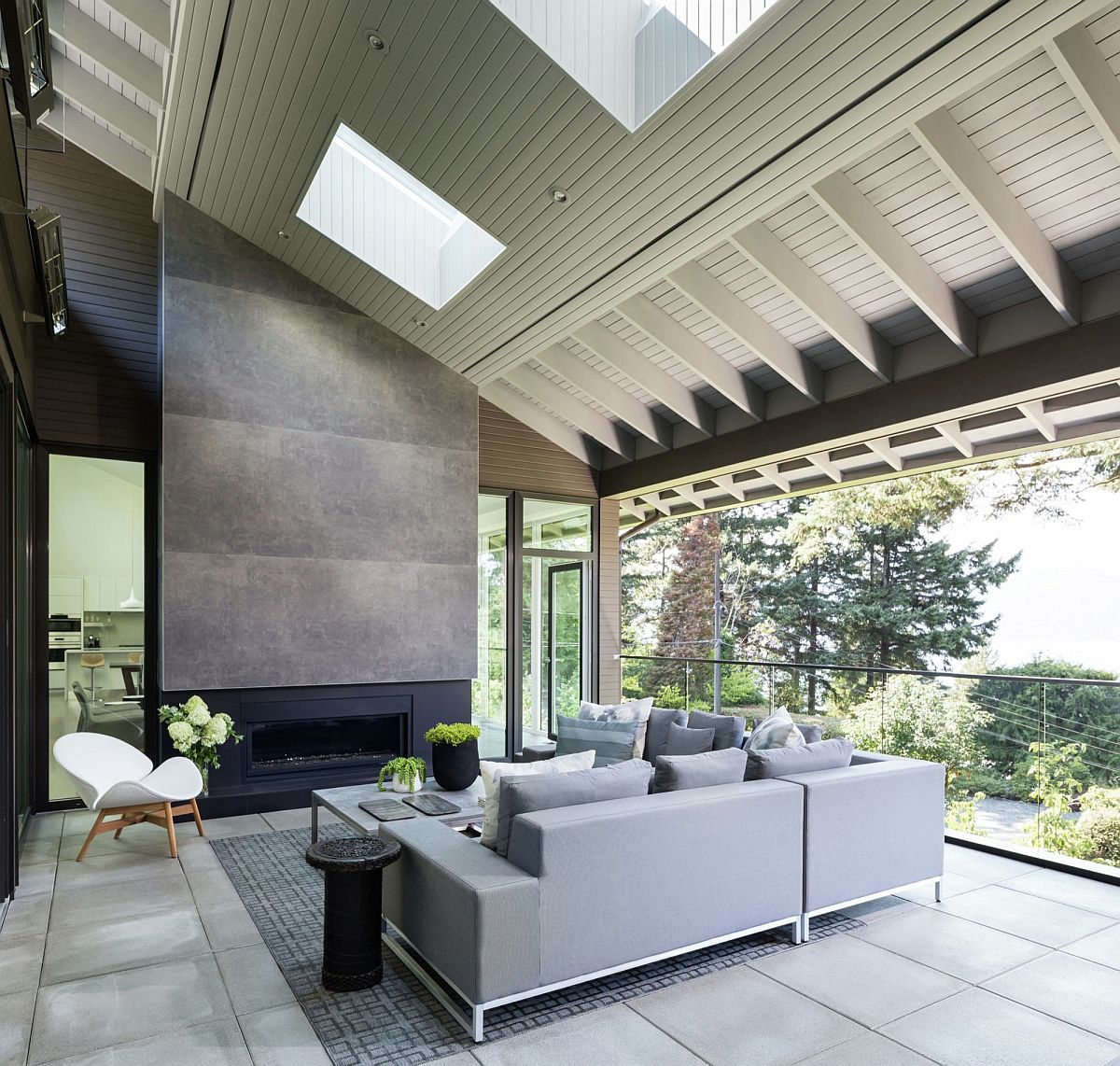 Open living room with vaulted ceiling, skylights and a smart fireplace