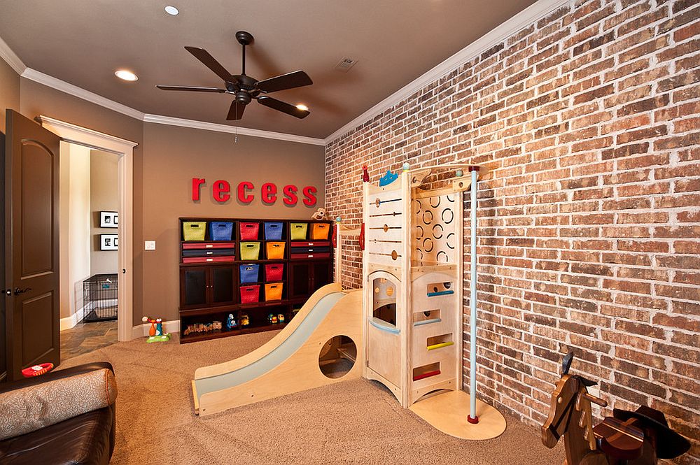 Organized playroom with brick wall and slide [Design: Drew Walling Custom Homes]