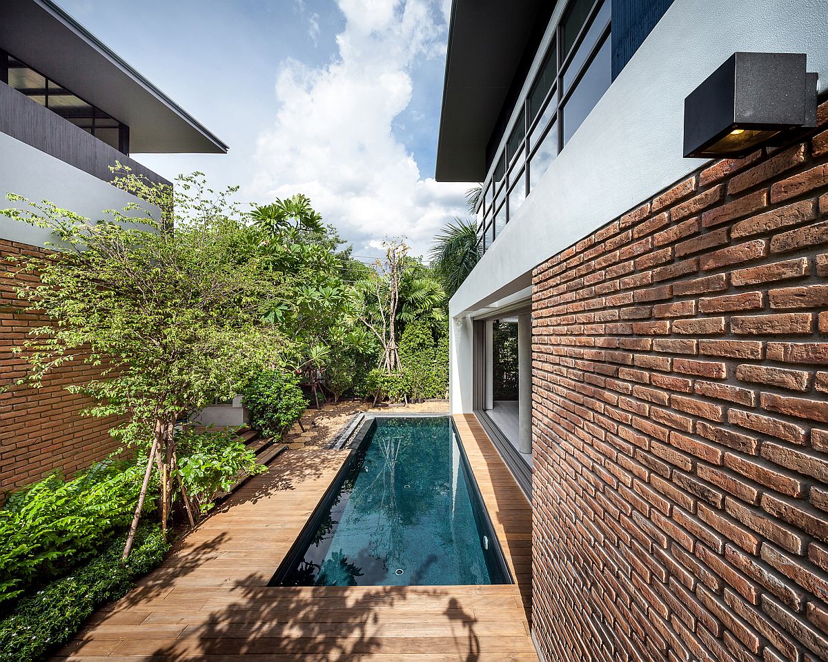 Patio and pool area connect the two houses in Bangkok, Thailand