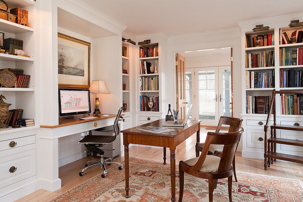 Picture lighting illuminates the open corner shelves in the home office beautifully