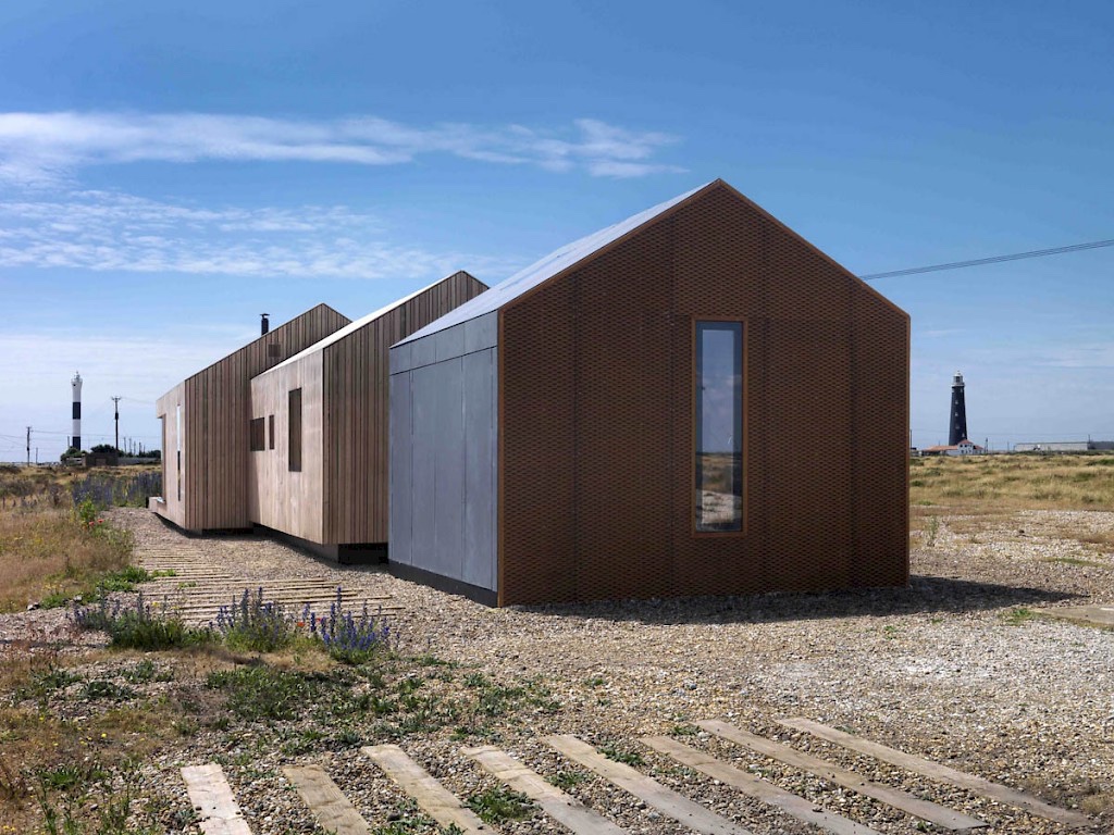 Pobble house clad in various materials.