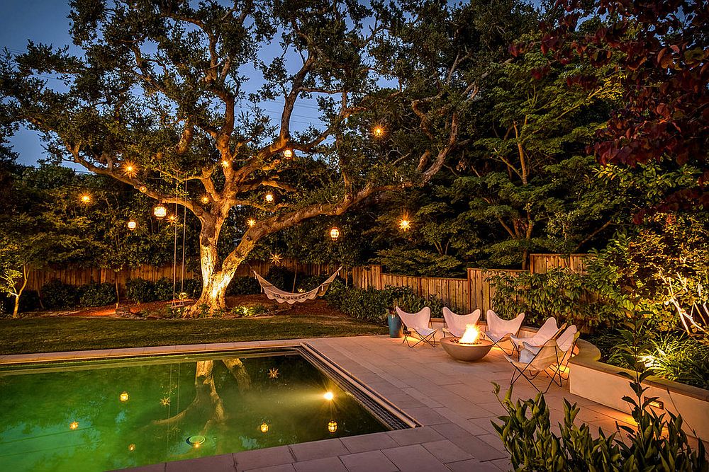 Poolside chairs, hammock and lanterns on trees for a mesmerizing backyard retreat! [From: Black Bear Builders]