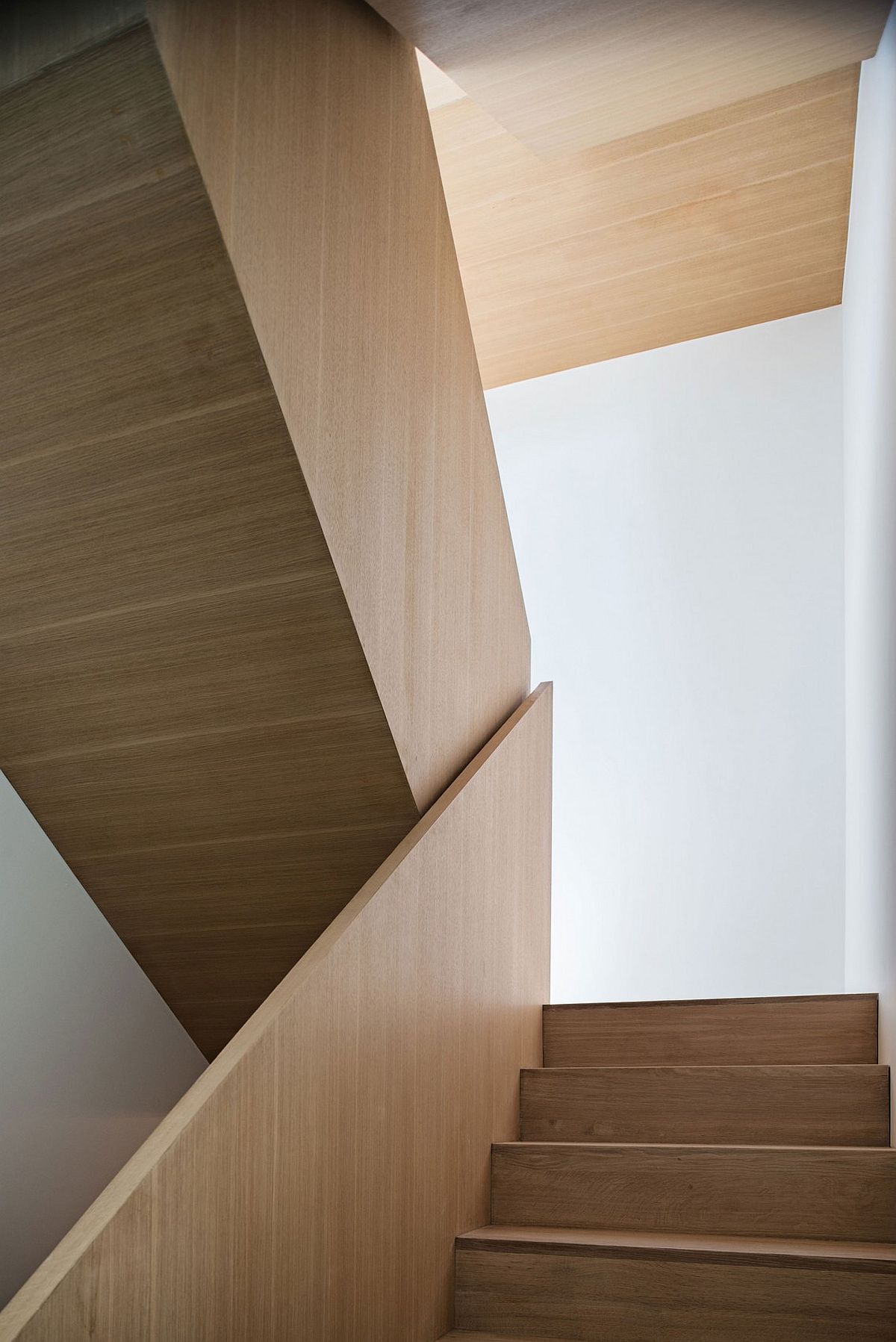 Sculptural wooden staircase inside the modern Toronto house