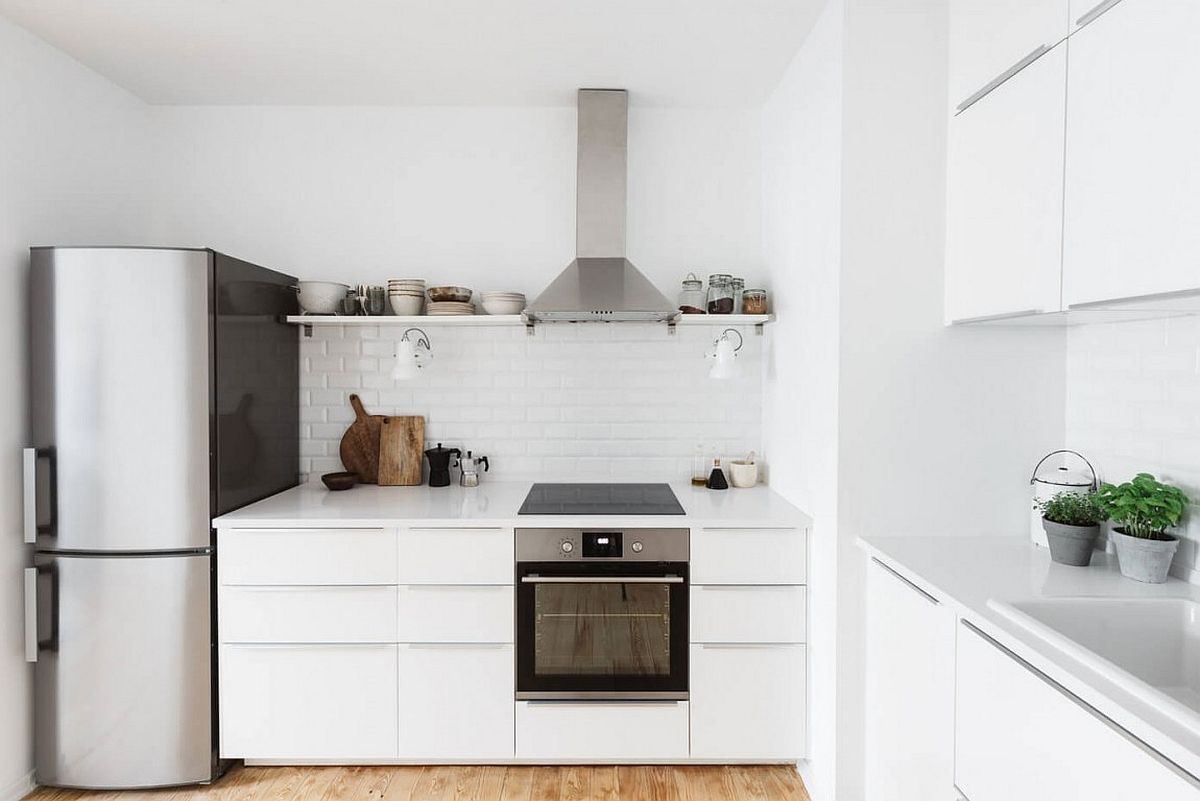 Small, all-white kitchen design with tiled backsplash