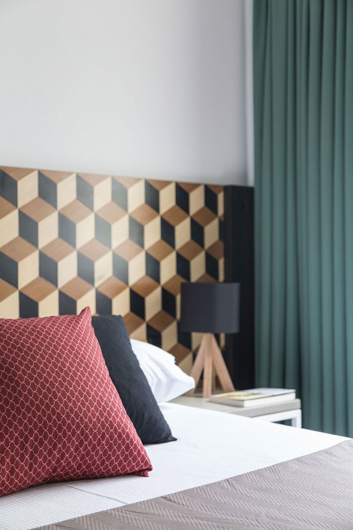 Small bedroom design with geometric wallpaper for the headboard wall