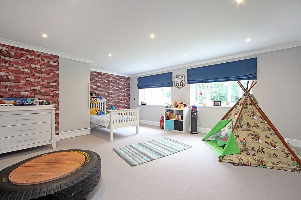 Spacious kids' bedroom with ample room for play area and exposed brick wall [Design: Noushka Design]