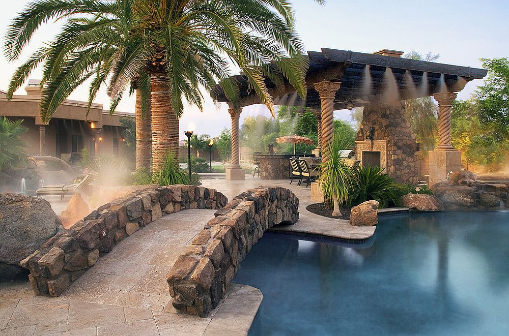 Stunning Mediterranean poolscape with stone siding that replicates natural stone