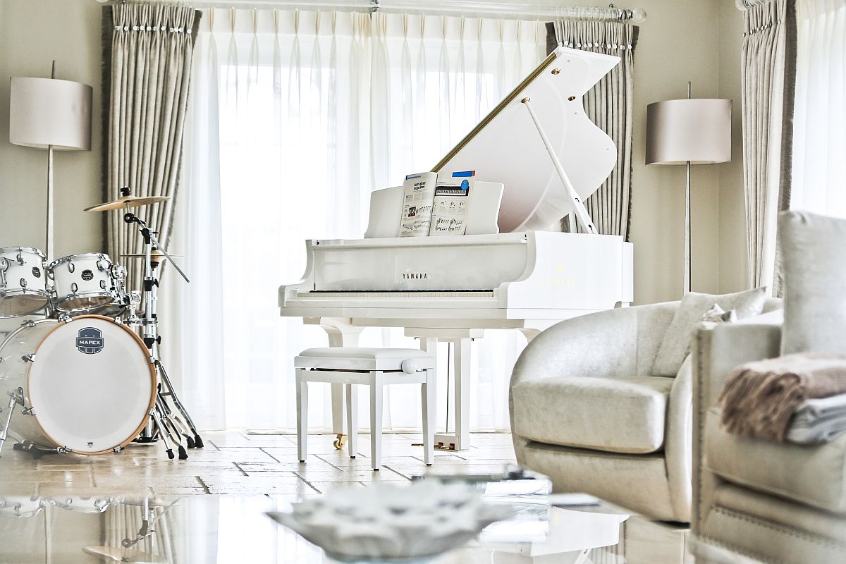 Stunning room in white with piano and drum set in matching color