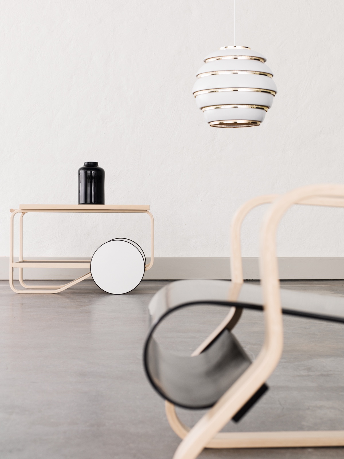 Clockwise from left: Tea Trolley 901 (1936), Pendant Light A331 (1953) and Armchair 41 "Paimio". The Paimio lounge chair was designed in 1932 for the the Paimio Sanatorium in Finland. Photo by Osma Harvilahti.