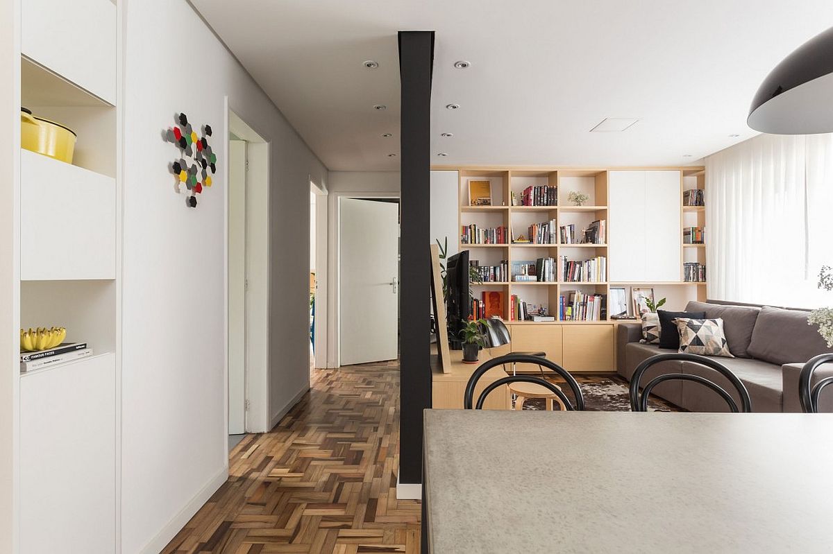 Unique herringbone pattern of the floor adds to the style of the small apartment