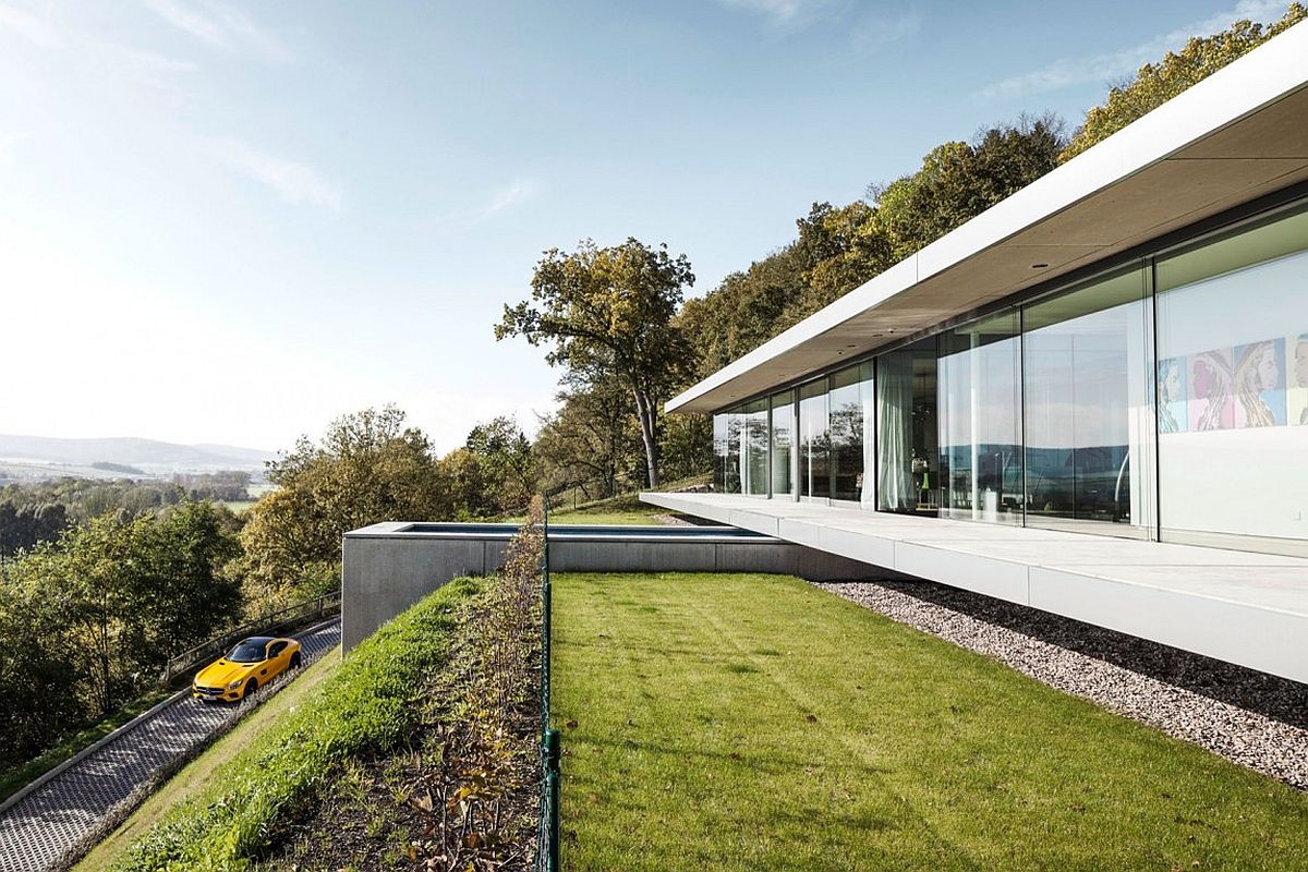 View of the pool and the road leading to beautiful Villa K in lush green landscape