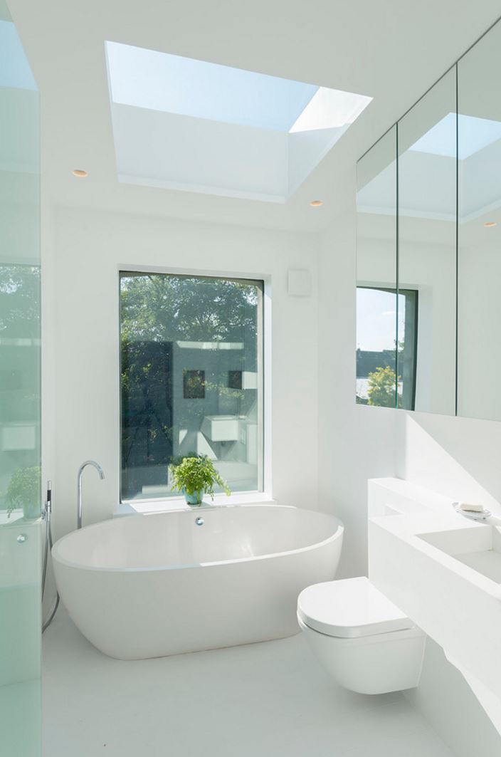 White bathroom with a plant in the window