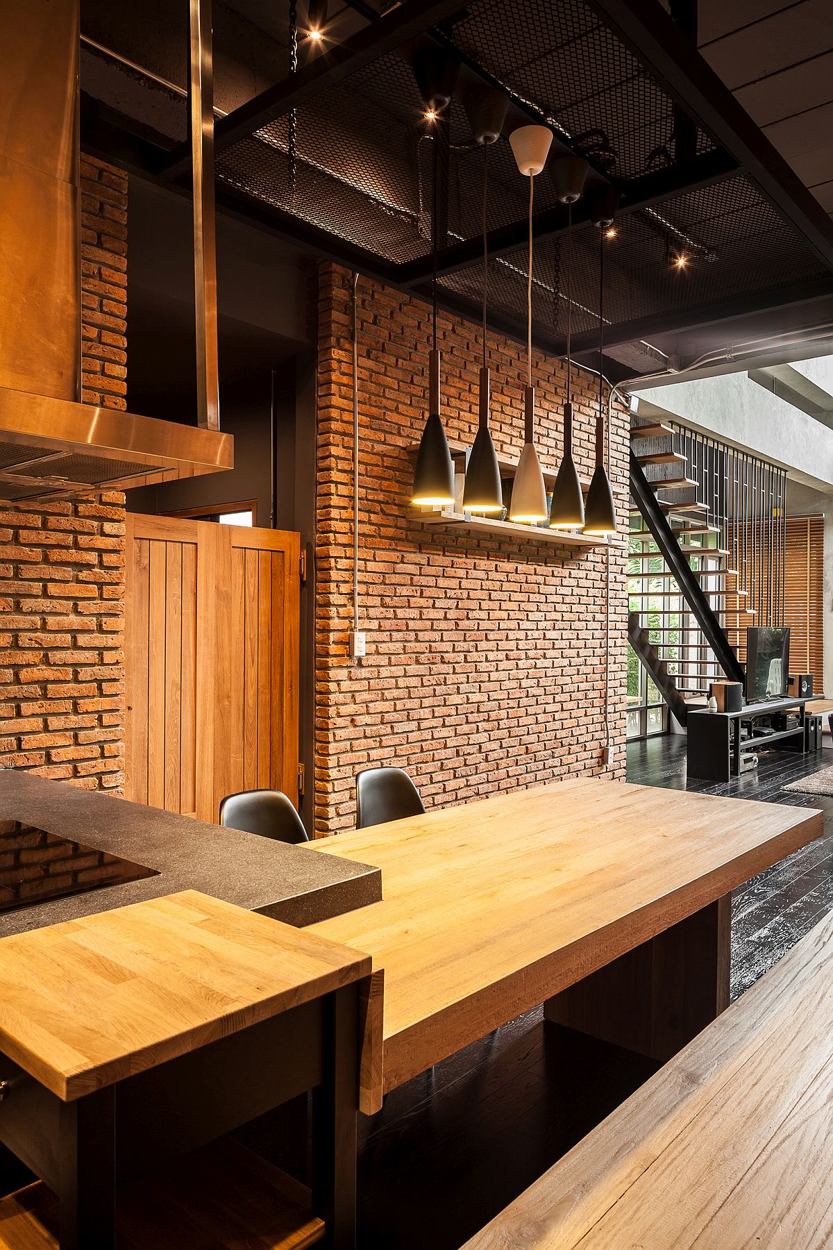 Wooden tables and industrial lighting for the kitchen and dining area