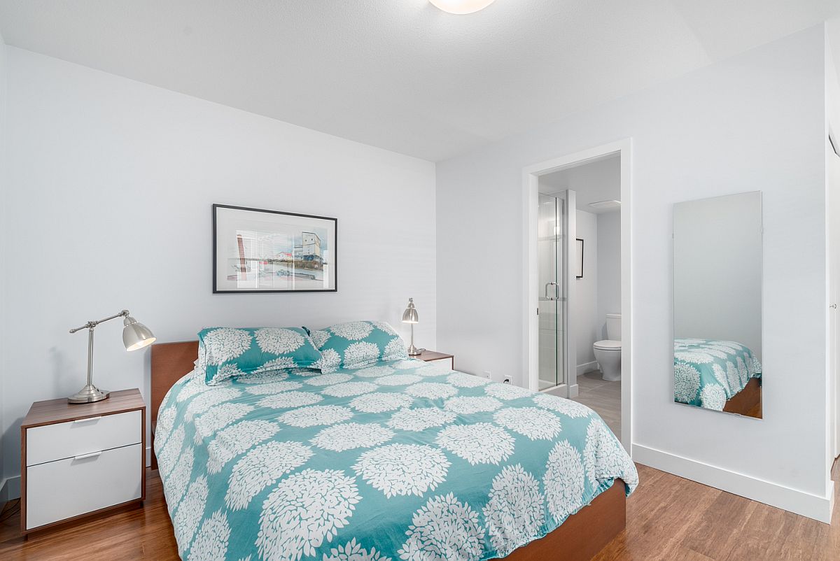 All-white bedroom with wooden sidetables and and table lamps