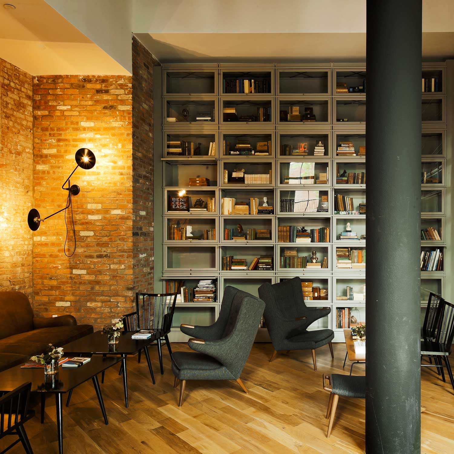 The steel, cast iron and brass Bent Wall Lamp is pictured in the Wythe Hotel.