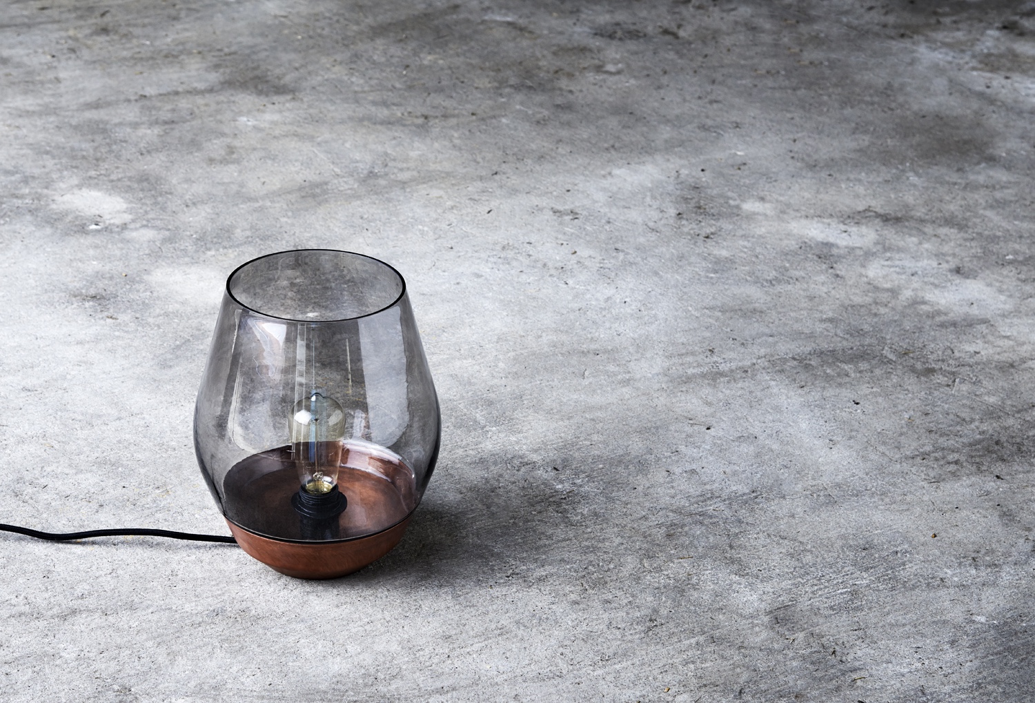 Bowl Table Lamp designed by Knut Bendik Humlevik. Shown in raw copper with light smoked glass. This design is inspired by a traditional lantern shape.