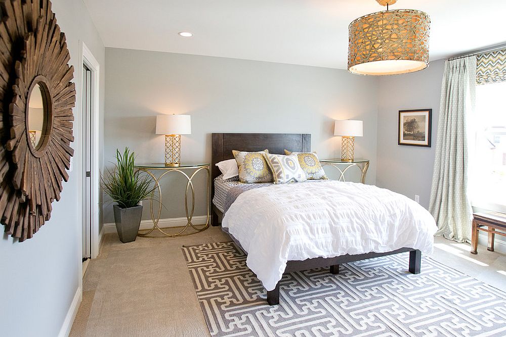 Contemporary bedroom with stylish gold nightstands and table lamps