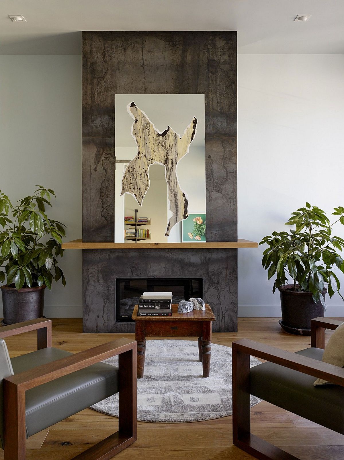 Creative decor and mirror transform the space surrounding the fireplace