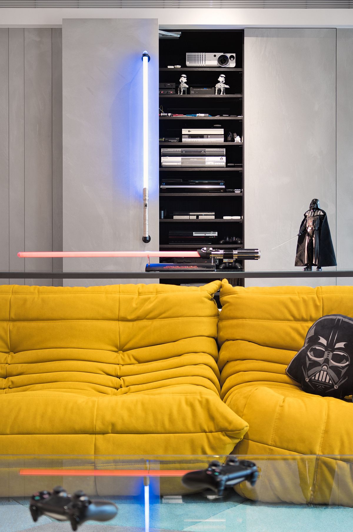 Darth Vader and light saber style lighting rules the living room of the Star Wars home