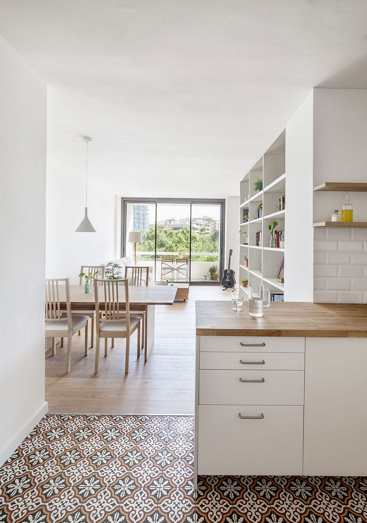 Dining area and kitchen in white with wooden accents