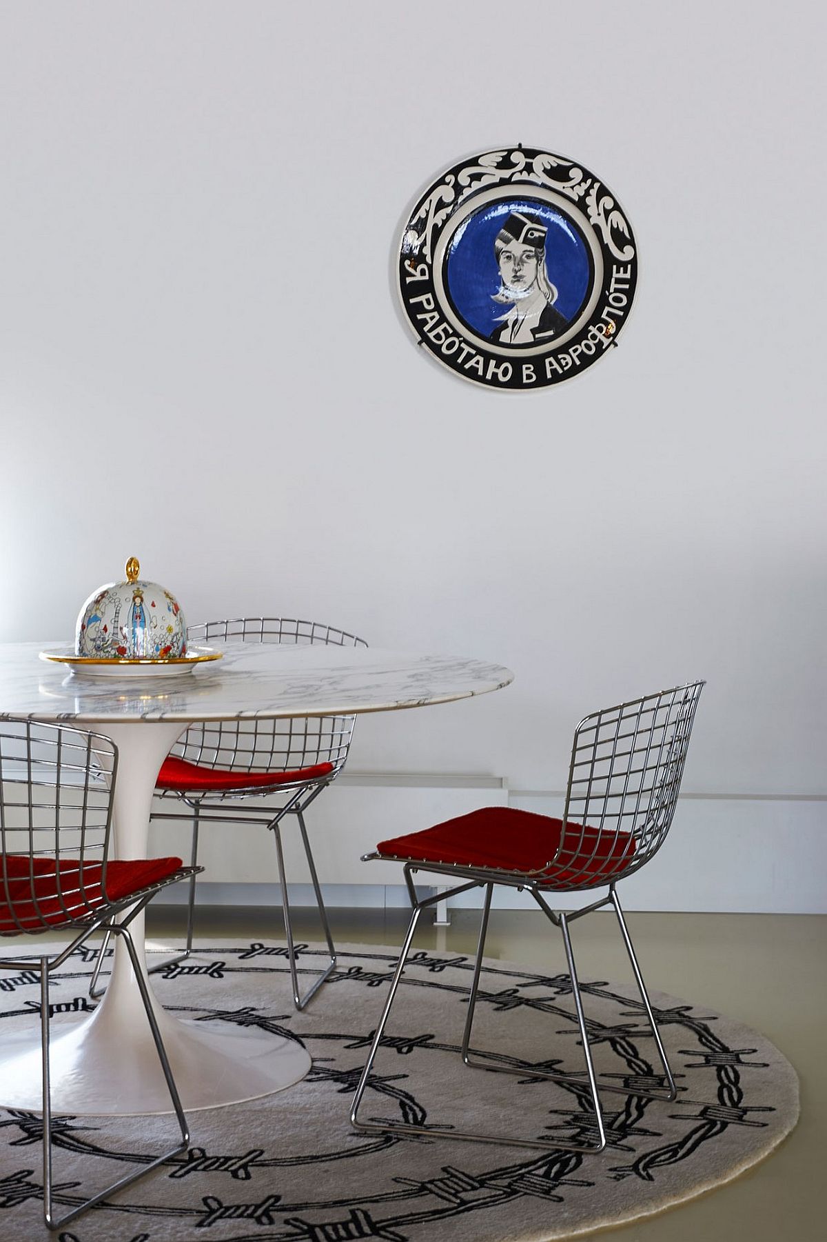 Dining area has a distinct midcentury modern appeal thanks to the Tulip table with marble top