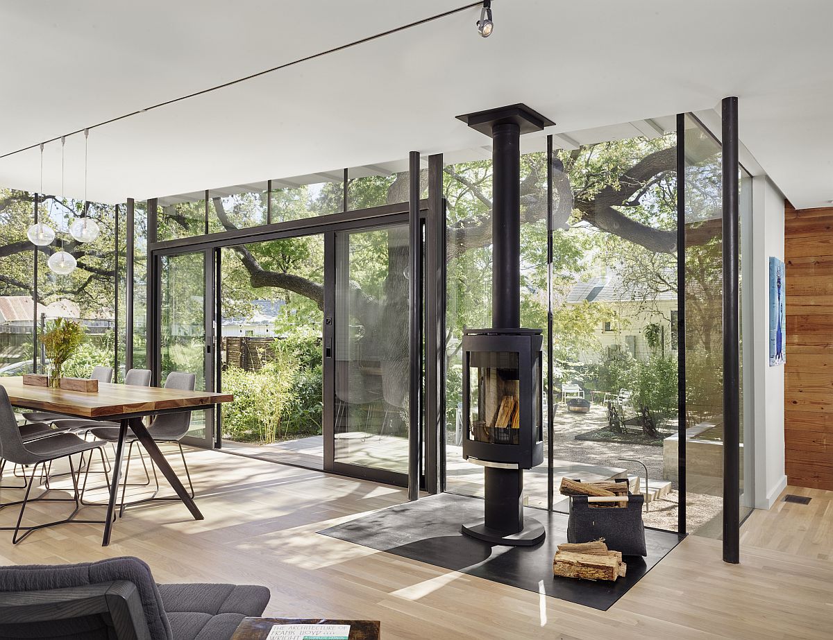 Dining room with glass walls and sliding glass door connected with the patio and outdoor living area