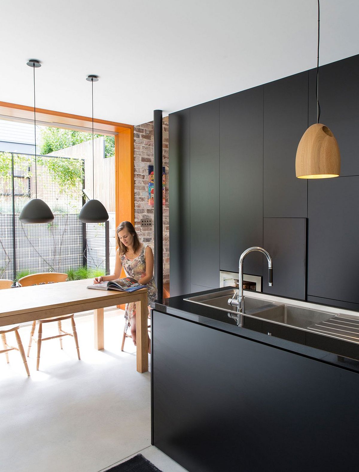 Dining space, kitchen and reading nook at the stylish Sydney home