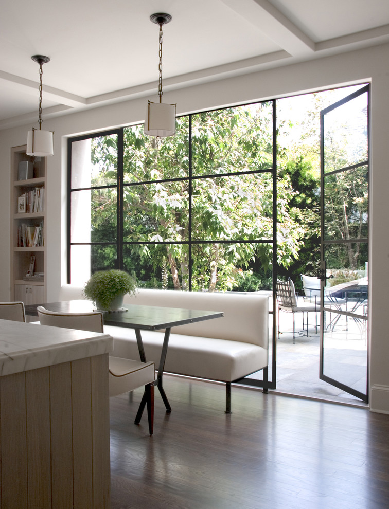 Eating area in a kitchen with floor-to-ceiling windows