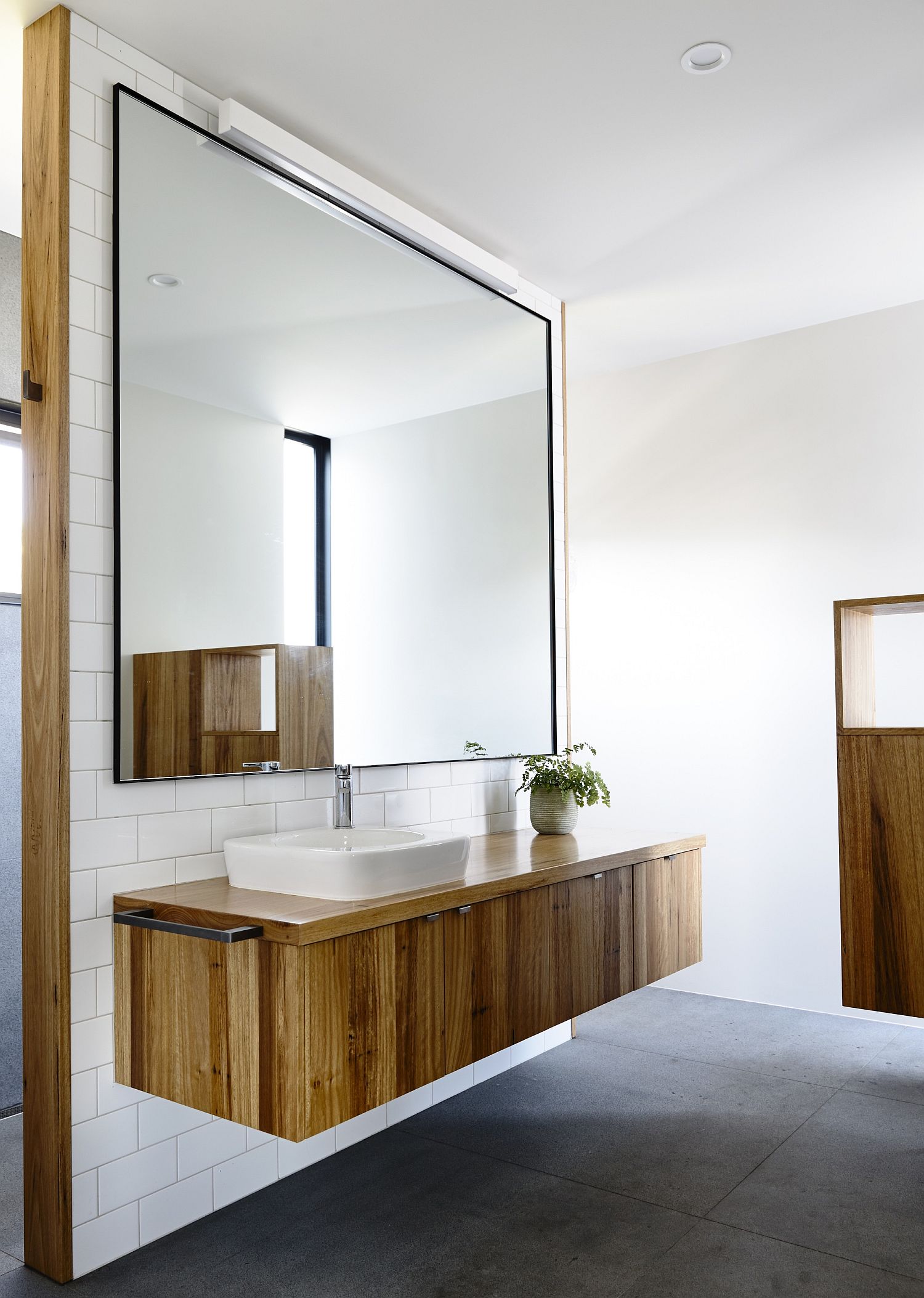 Fabulous floating vanity in wood with giant mirror above