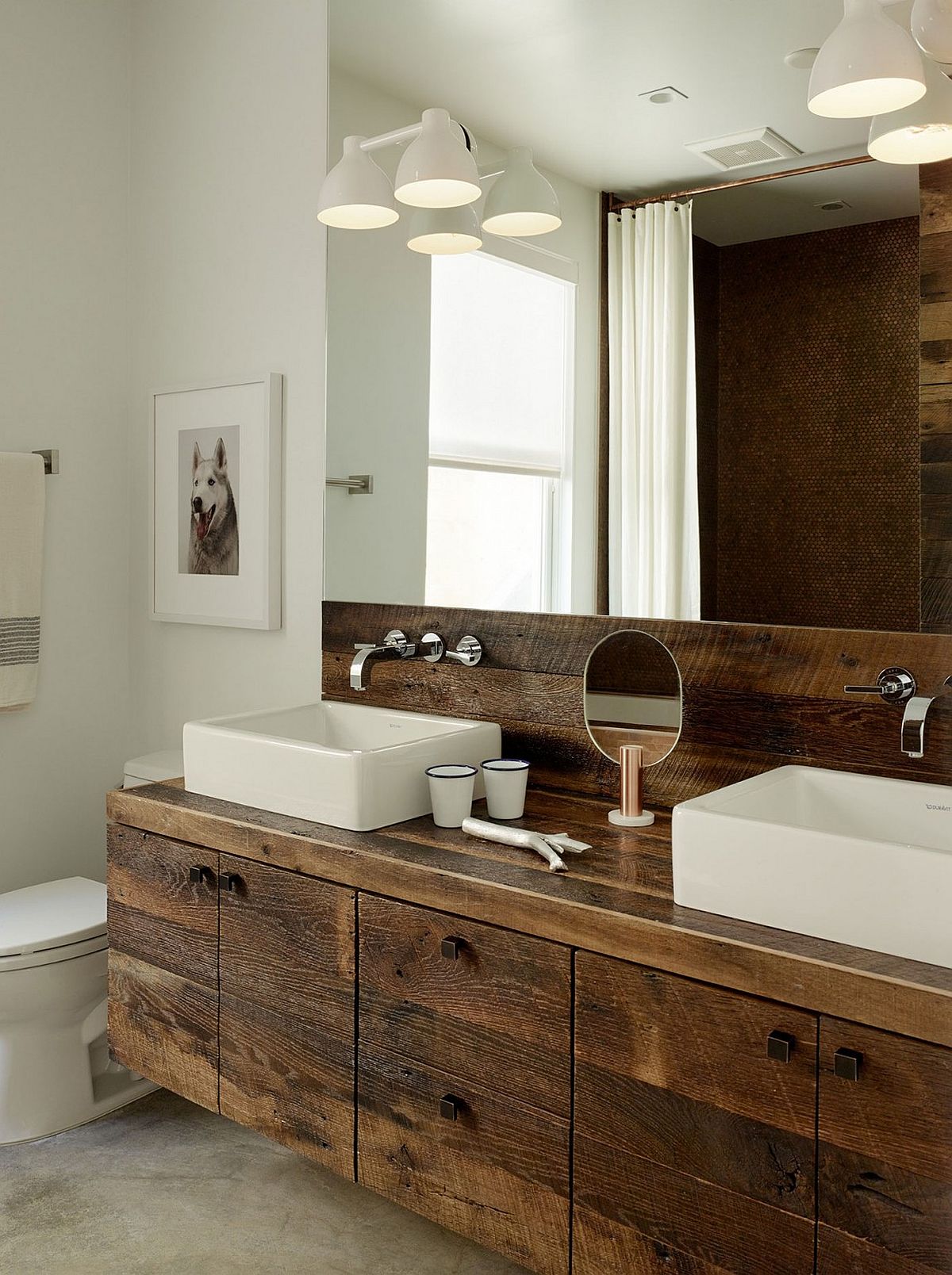 Floating wooden vanity and backsplash give the bathroom an organic twist