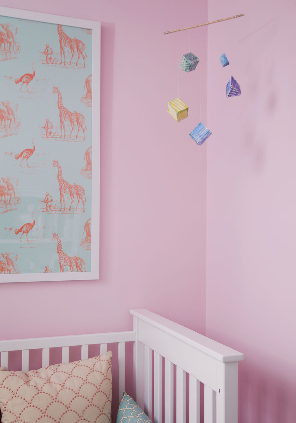 Framed wallpaper in a pink nursery