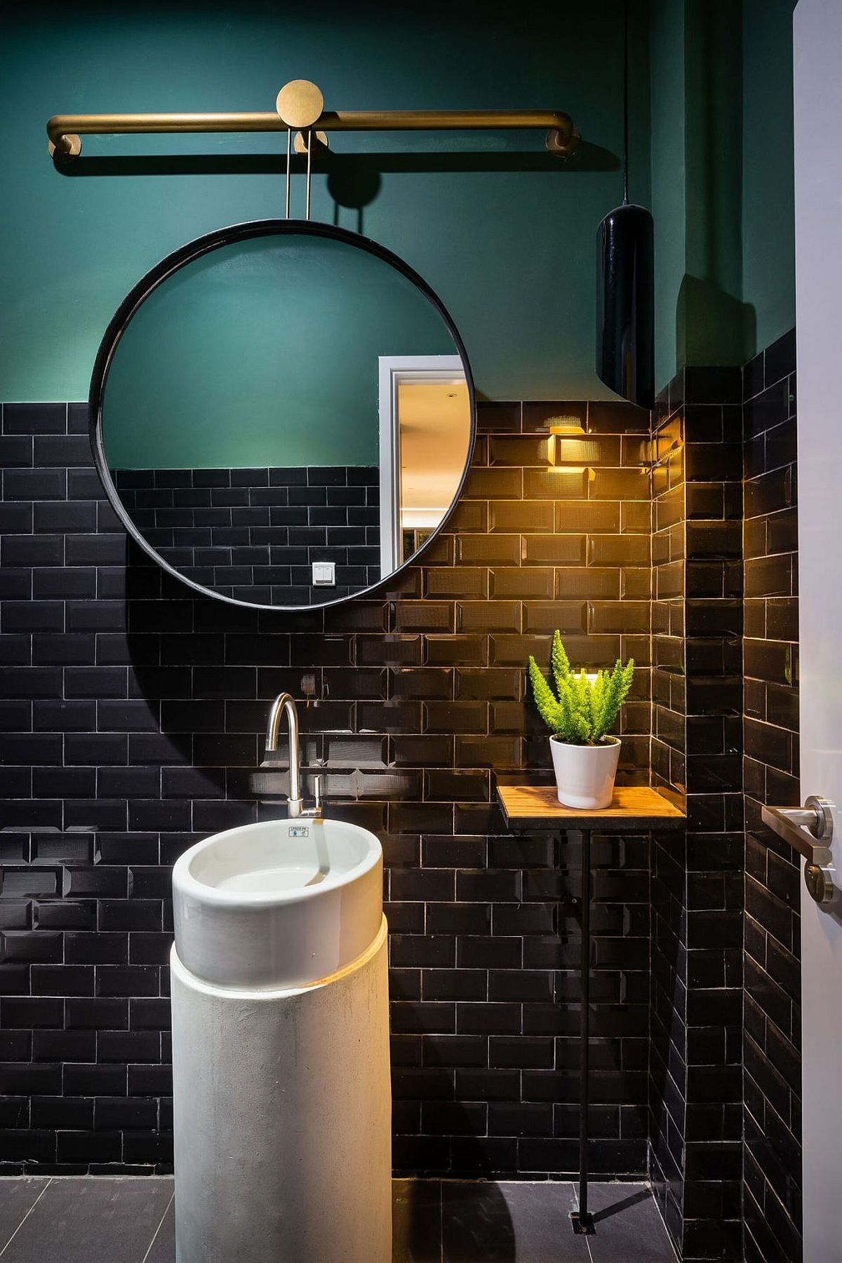 Gorgeous use of color and brass acceents in the small bathroom