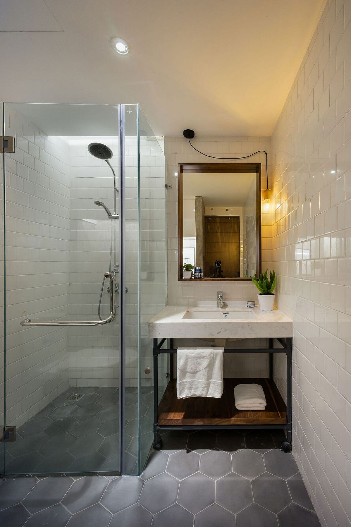 Hexagonal floor tiles bring geometric beauty to the small bathroom