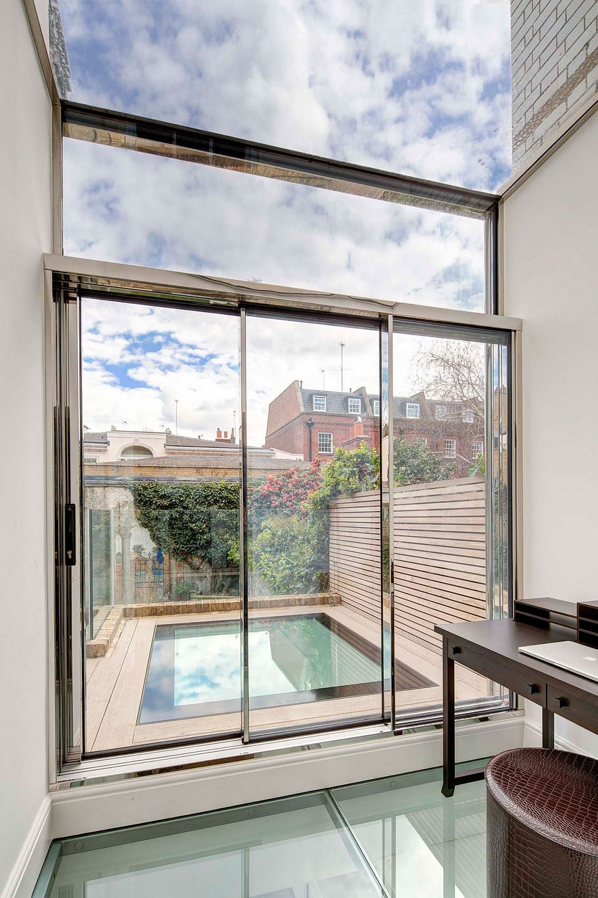 Home office connected with the top level deck that features a walk-on skylight