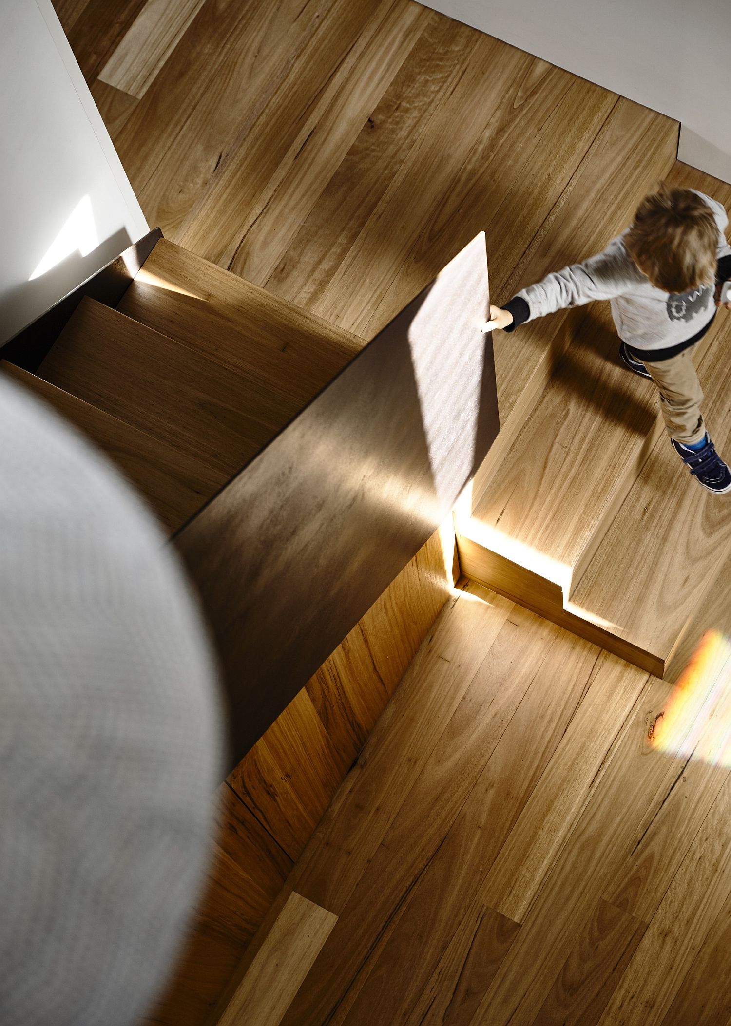 Illuminate wooden staircase leading to the bedroom level