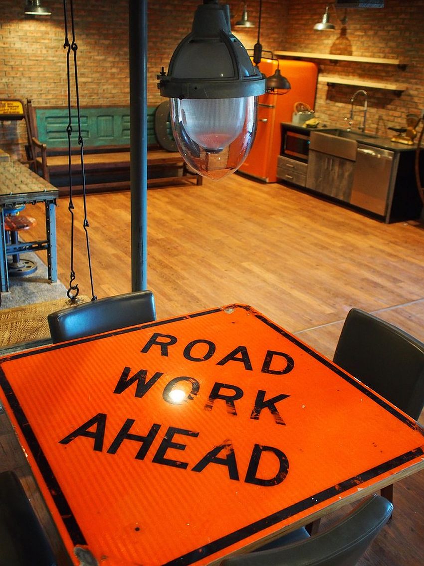 Industrial dining table crafted out of a road sign and reclaimed wood