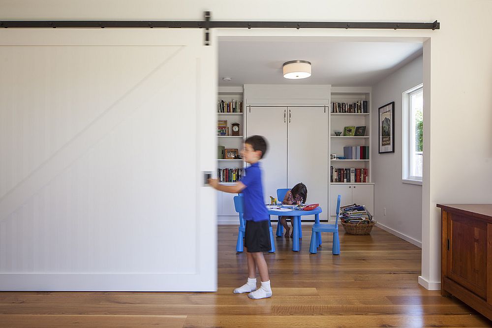 Kids' study area and playroom delineated from the rest of the home using sliding barn door