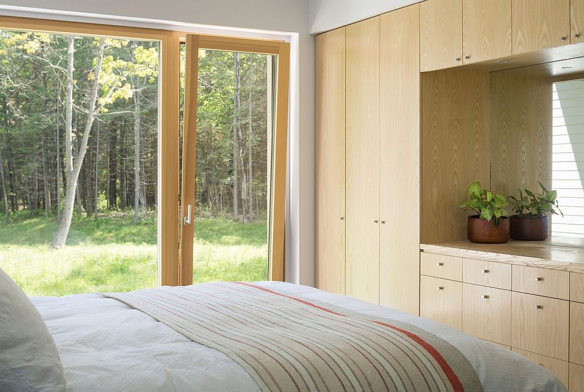 Large doors connect the bedroom with the pine forest and scenery outside