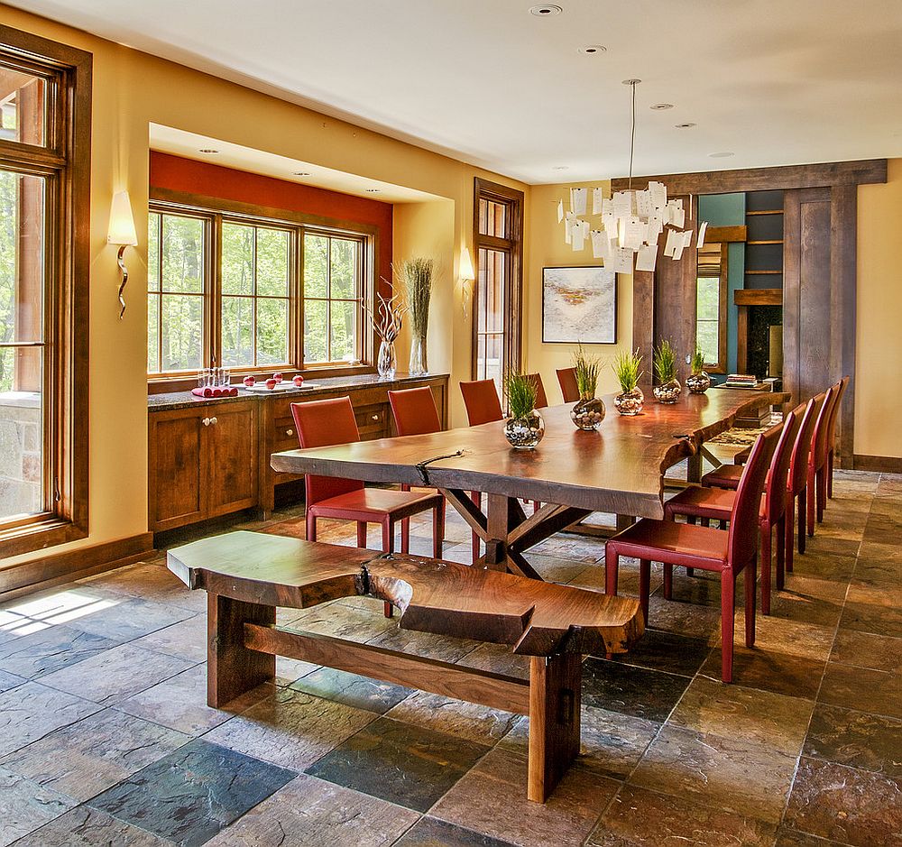 Live edge bench and dining table paired with colorful red chairs