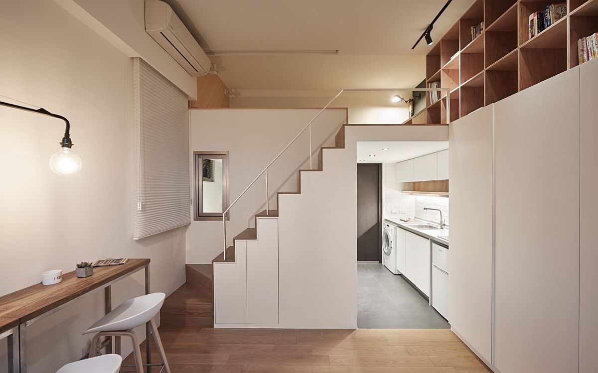 Look at the small kitchen, living are and mezzanine level of the tiny apartment