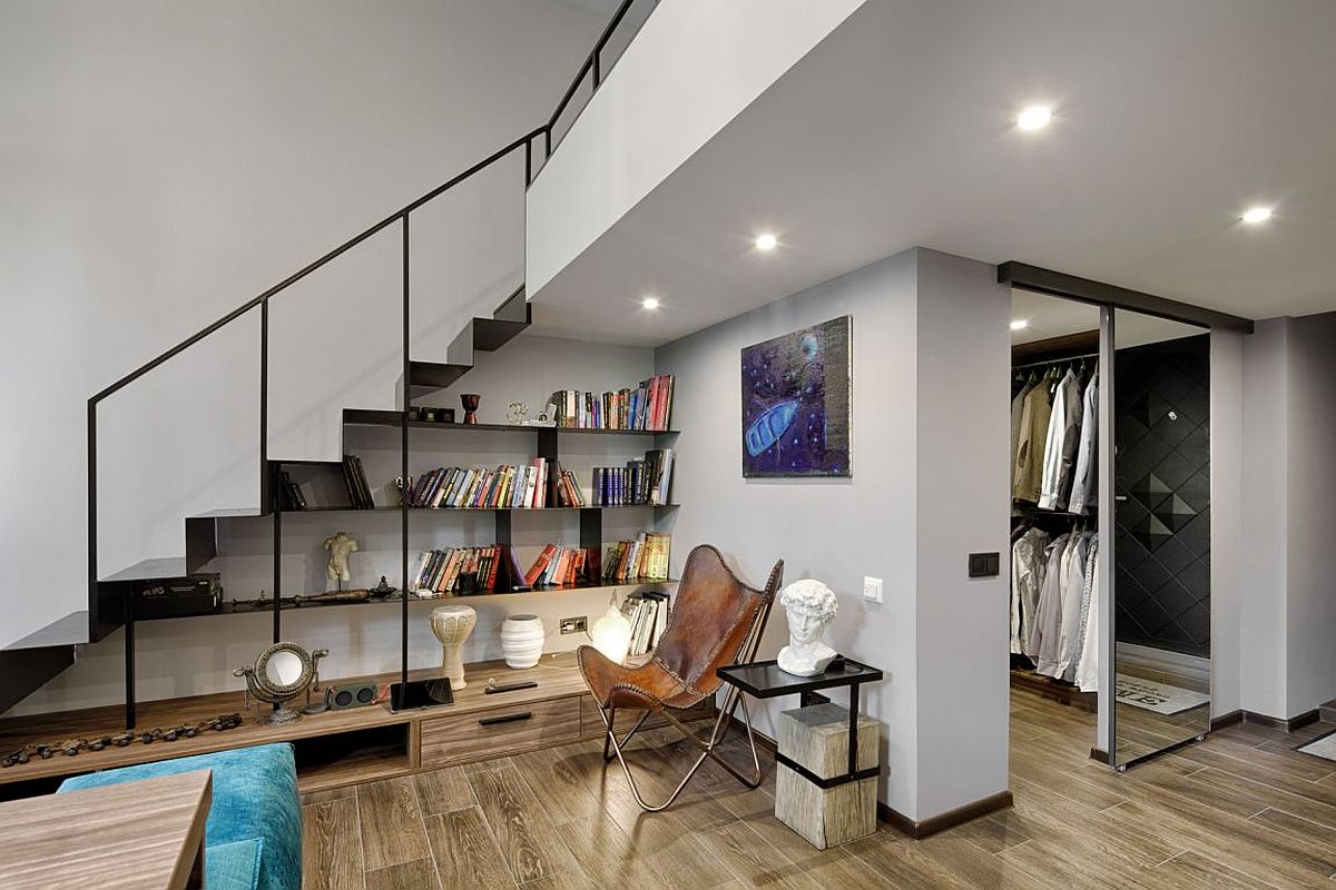 Making use of space under the stairs by turning it into a redaing nook with open bookshelves