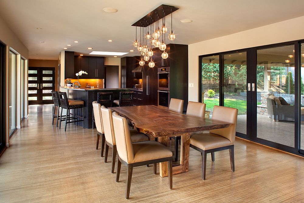 Midcentury modern dining room taps into the raw beauty of a live edge table [Design: Giulietti Schouten Architects]