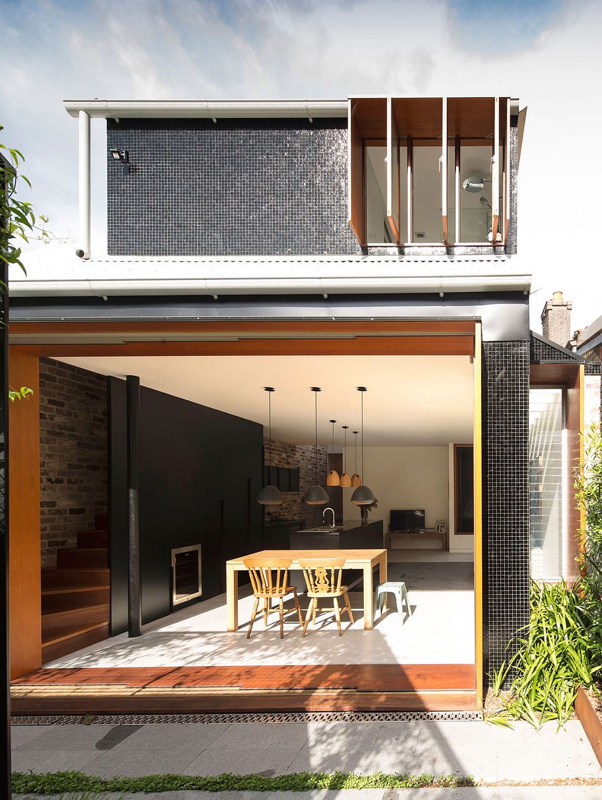 Open living area with kitchen and dining connected to the rear garden