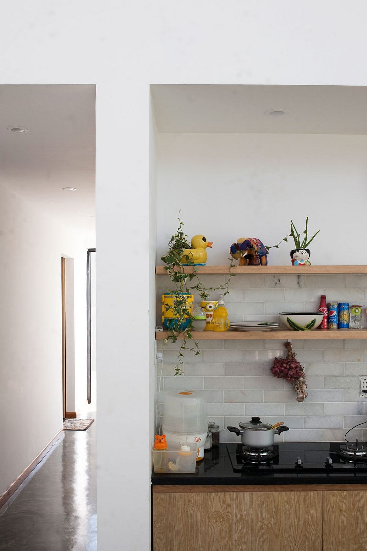 Open shelves above the kitchen counter at the stylish modern house in Vietnam