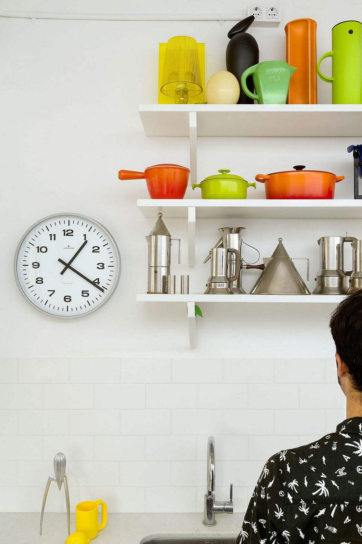 Open shelves in the kitchen create an airy ambiance and double as lovely display in the small space