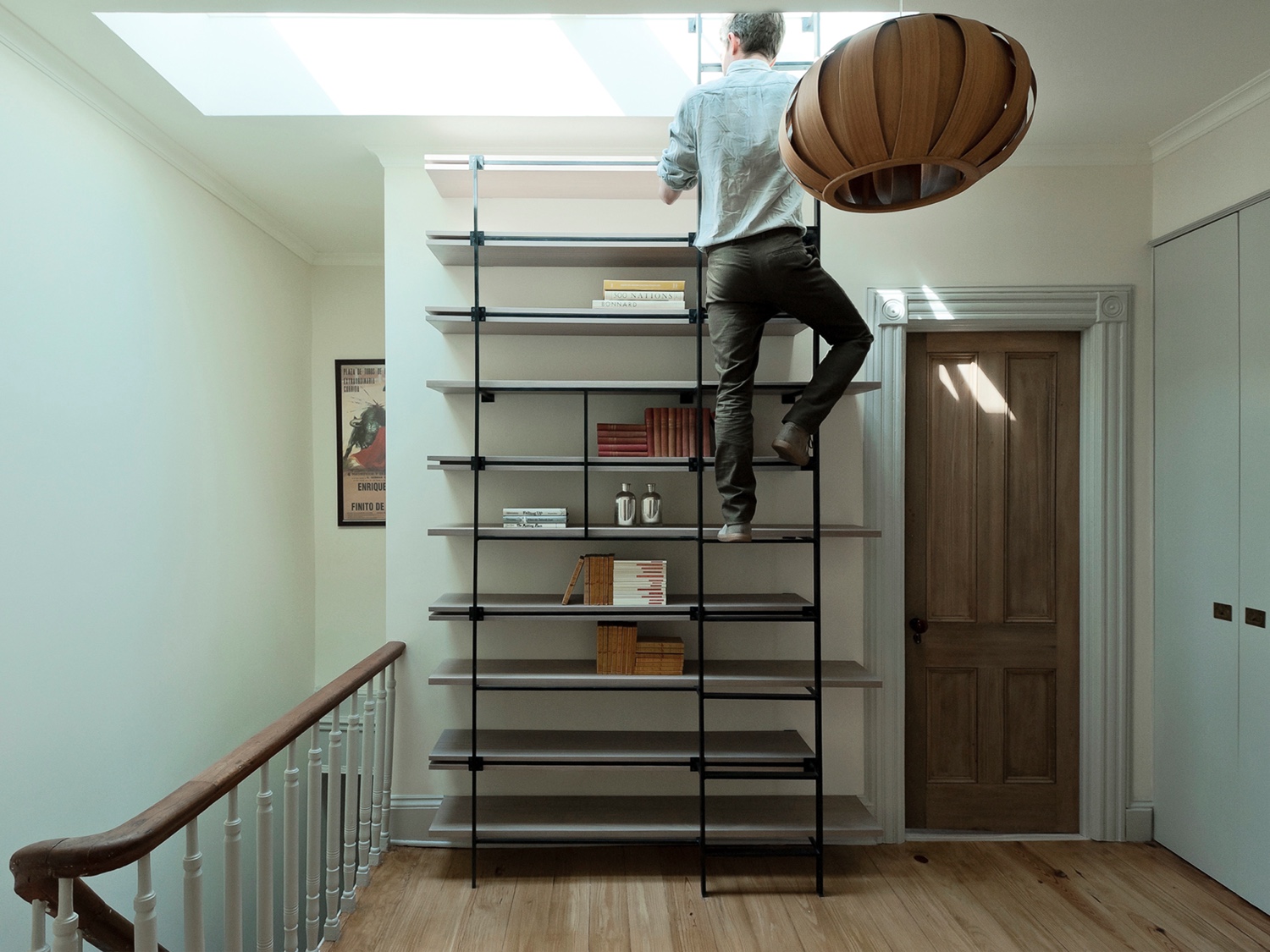 The bespoke book shelving in this Brooklyn residence incorporates a steel ladder that leads to a workable skylight.