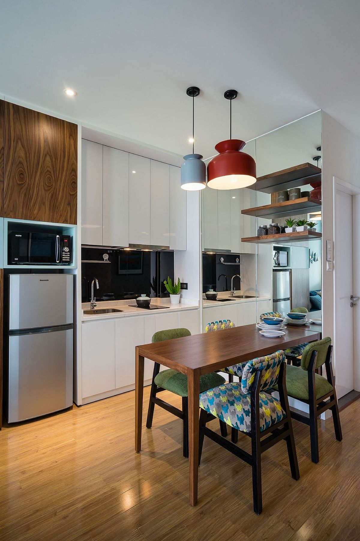 Pendant lights and metallic finishes give the kitchen and dining an airy ambiance