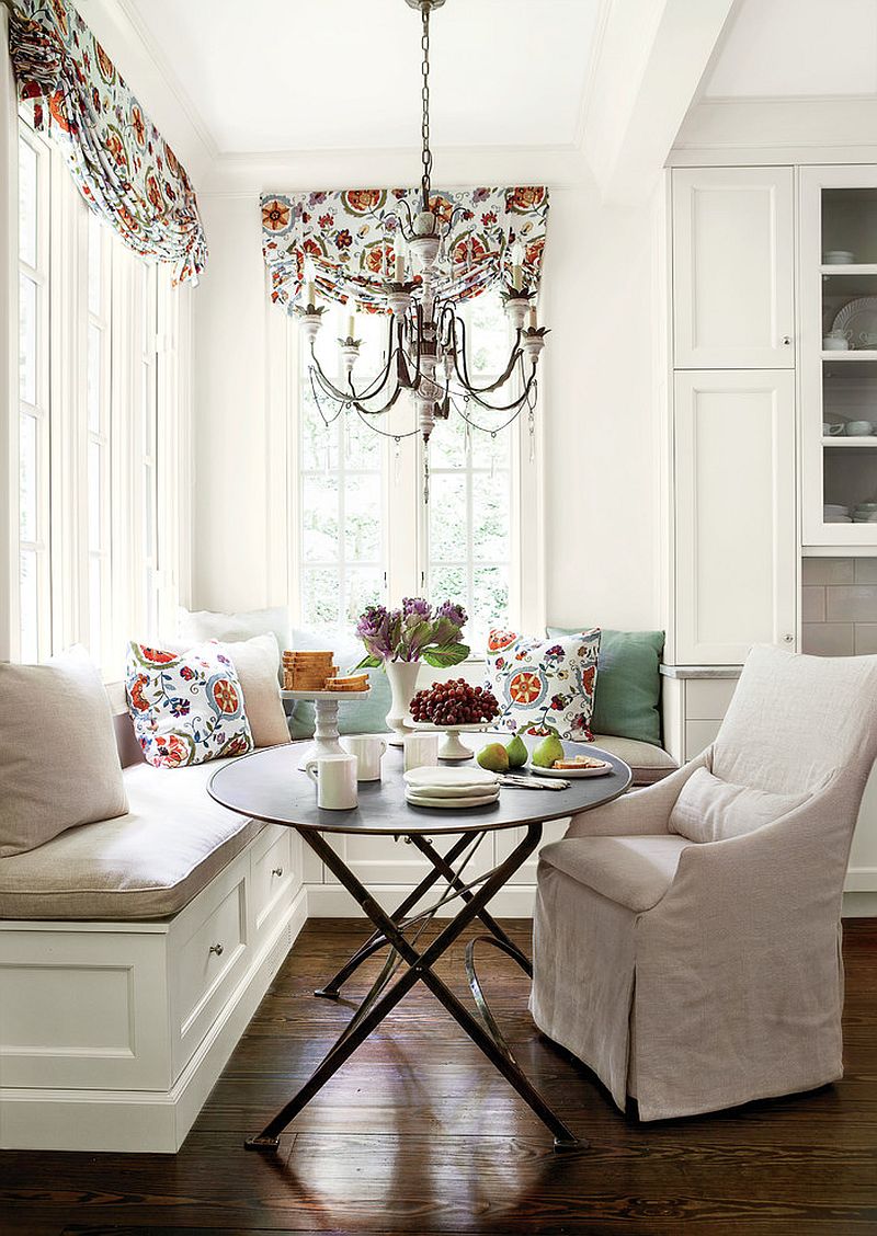 Pillows and drapes add color and freshness to the all white banquette [From: Erica George Dines for Southern Living]