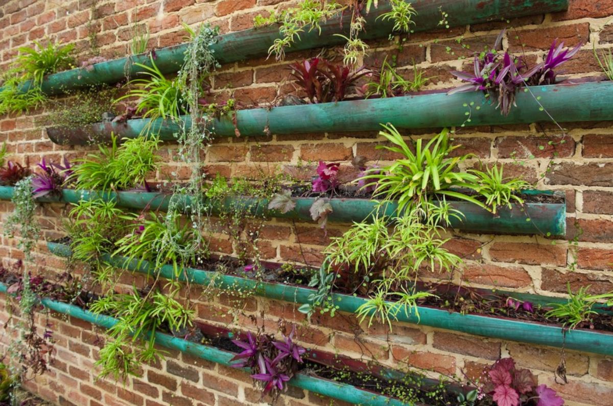 Rain gutter garden with copper vessels