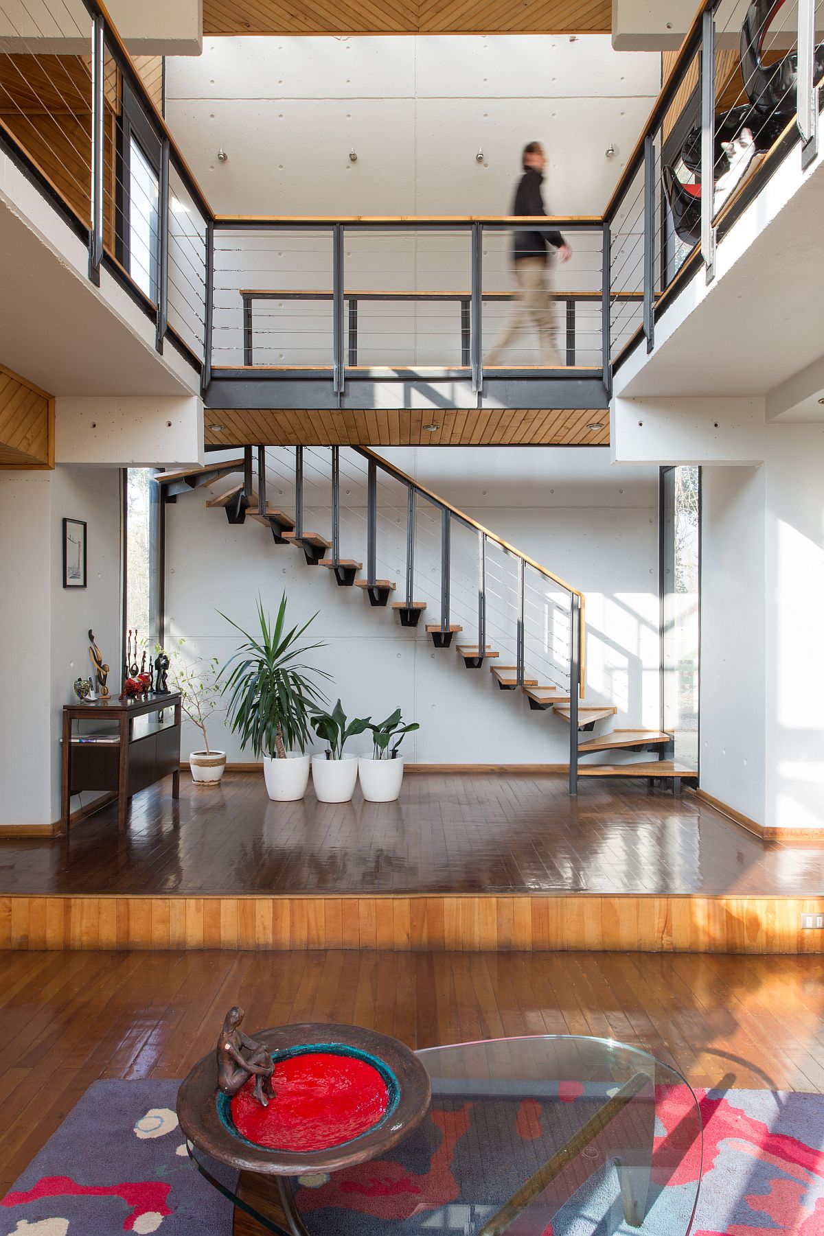 Sculptural staircase illuminated by natural sunlight